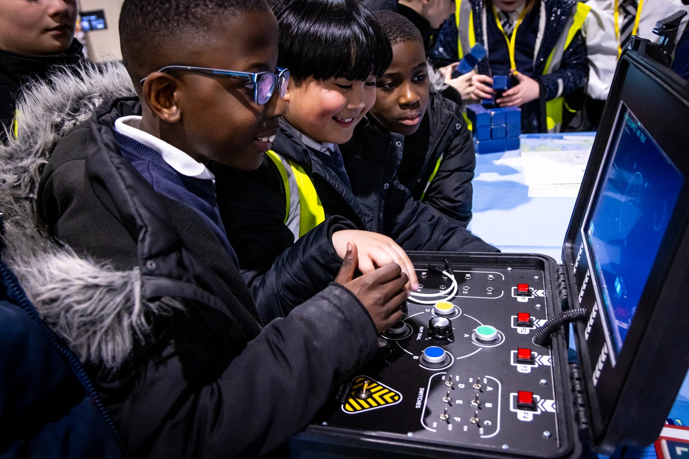 Boys learning from an interactive controller.
