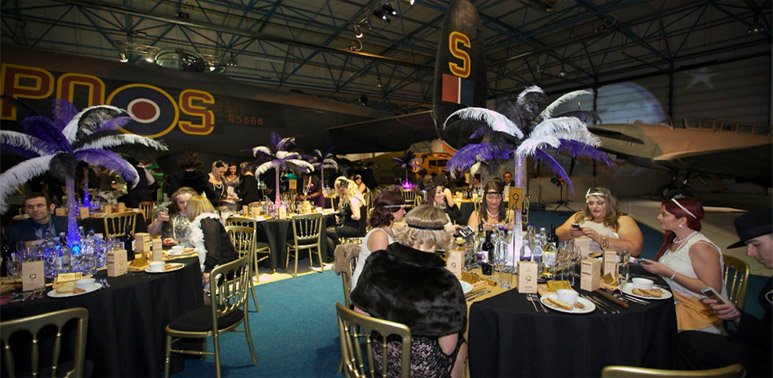 Evening dinner event set beneath the Lancaster aircraft.