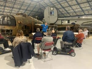 A tour guide with a group from Age UK Barnet