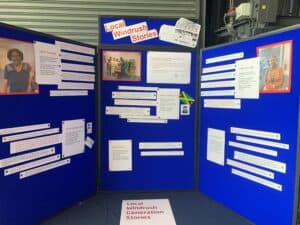 Blue display boards with text and images with the title Local Windrush Stories