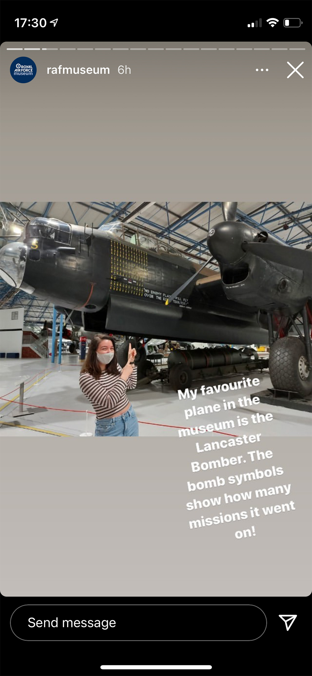 Member of our Youth Panel in normal clothing standing underneath Lancaster Bomber S for Sugar