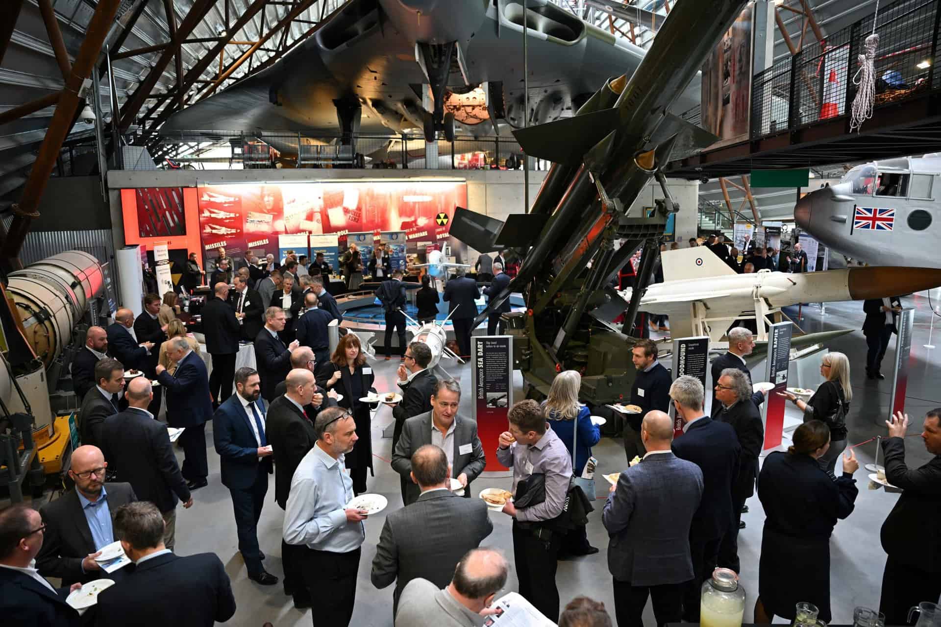 Boardroom setup with bottles of water and notepads.