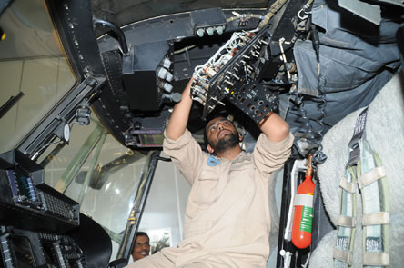 One of the Royal Air Force of Oman's highly skilled technicians working on a RAFO Helicopter One of the Royal Air Force of Oman's highly skilled technicians working on a RAFO Helicopter