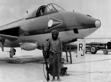 A Hawker Hunter FR10 flown by Fl Lt Richard Johns of No 1417 Flight at RAF Salalah in 1965. The aircraft is guarded by a local Omani, that the pilots nicknamed 'Elvis'