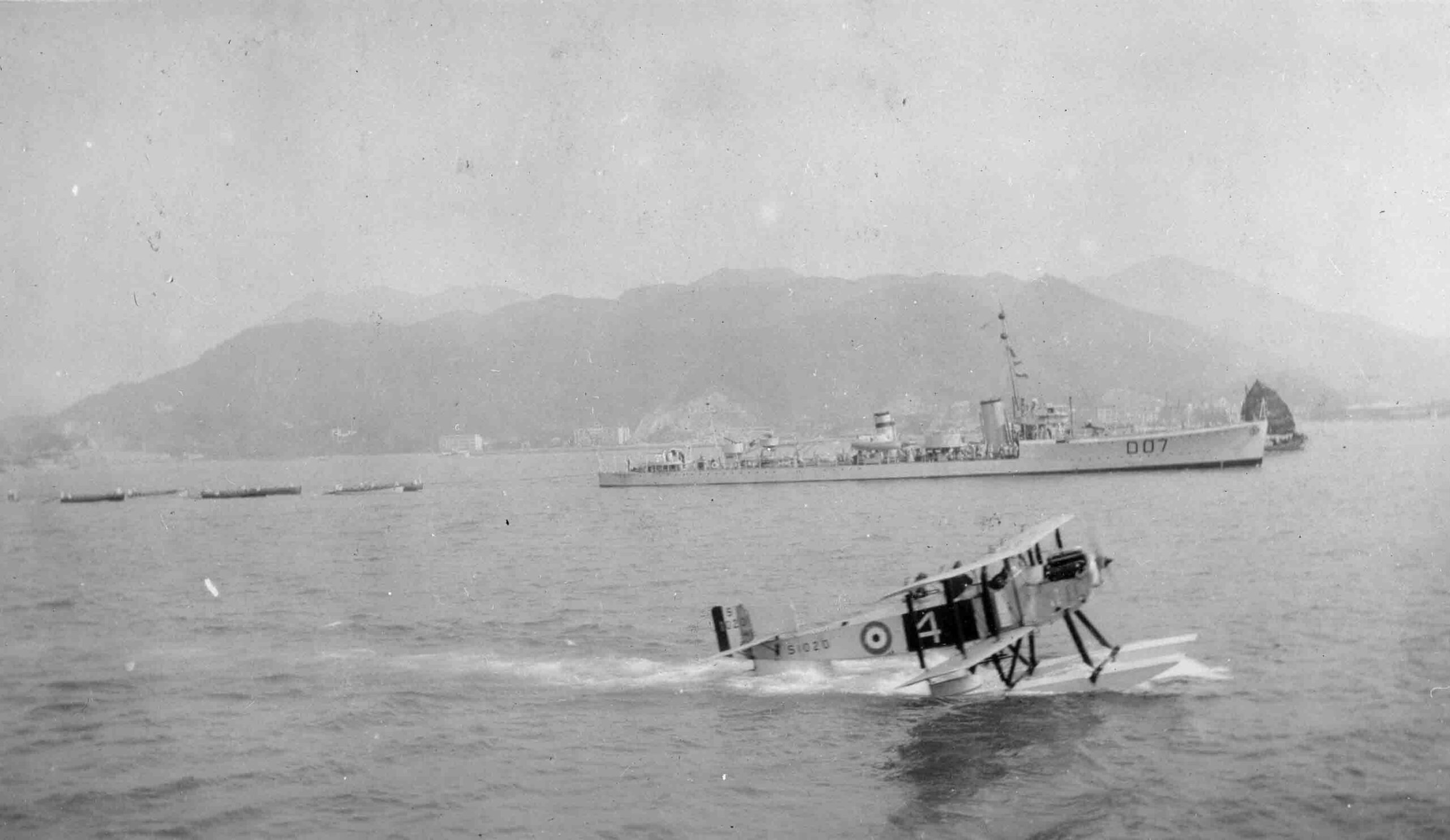 Fairey IIID taxying on water at Hong Kong in front of County Class destoyer, circa 1925 (P022428)