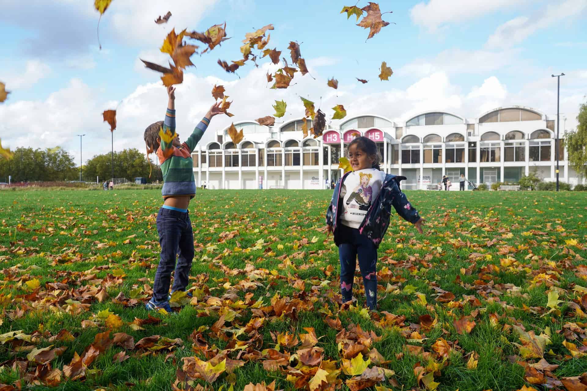 Children Playing with leaves on Museum grounds