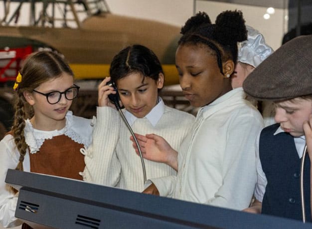 Children reading about an aircraft on an RAF Museum London Hangar.